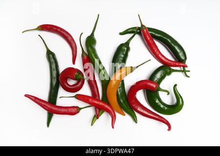 Multicolored hot chili peppers on a white background. Stock Photo
