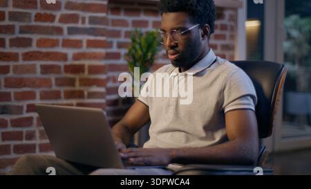 Thoughtful businessman African American guy thinking business man searching idea in evening office consider decision male trader employee think Stock Photo