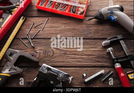 Tools and Equipment Spread Across a Wooden Surface in a Workspace During the Daytime Stock Photo