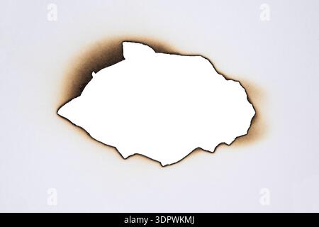 Burned Hole with Brown Edges in Paper Isolated on White Background Stock Photo