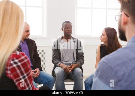 Group Discussion Takes Place in a Bright Room During a Support Session in the Afternoon Stock Photo