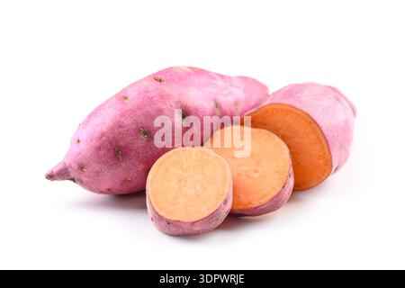 Raw sweet potato with sliced pieces isolated on white background. Healthy root vegetable food Stock Photo