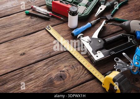 Tools Spread on Wooden Surface for Various Tasks in Workshop Setting During Daytime Stock Photo