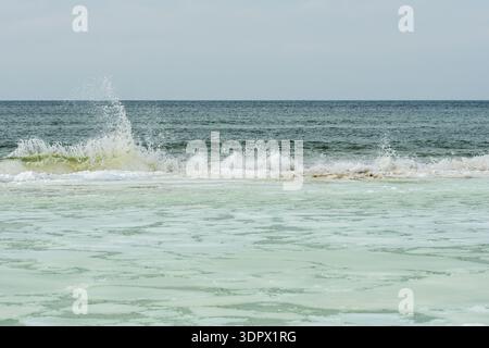 Icy winter seascape with frozen waves, floating ice floes on the sea water along a snowy shoreline on the Baltic Sea in Palanga, Lithuania Stock Photo