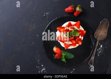 Fresh Strawberries on a Layered Dessert With Mint Leaves on a Dark Background Stock Photo