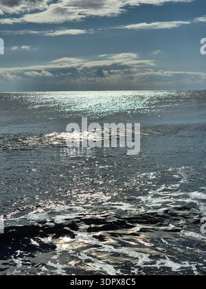Sunlight reflecting on the sparkling sea waves. Stock Photo