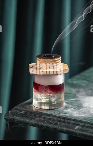 Smoked layered cocktail with wooden lid Stock Photo