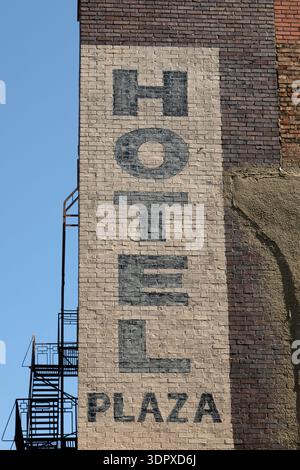 Sign for the Hotel Plaza in Joliet, Illinois, USA. The sign is hand-painted onto brickwork. Stock Photo