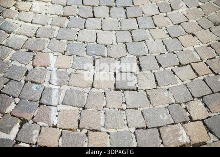 Exterior flooring made from natural stone cubes, commonly known as cobblestones or cobblestones Stock Photo