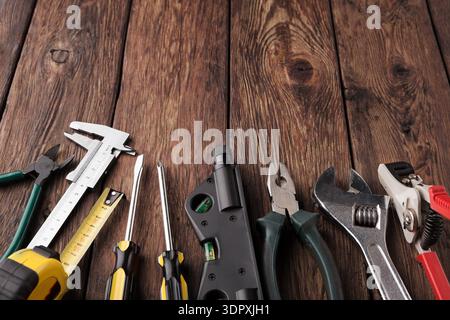 Various Tools Arranged on a Wooden Surface Showing Different Types and Uses for Crafts and Repairs Stock Photo