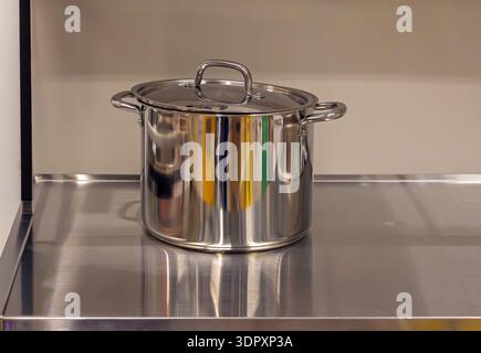 Closed silver metal pot on kitchen surface Stock Photo