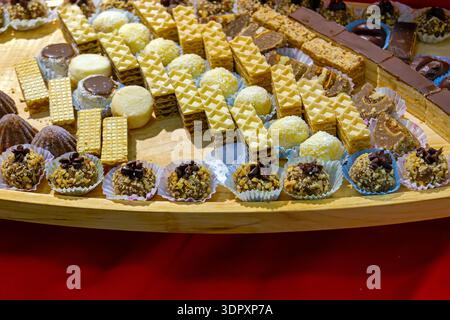 Small sweets cake pieces on a tray served at home party Stock Photo