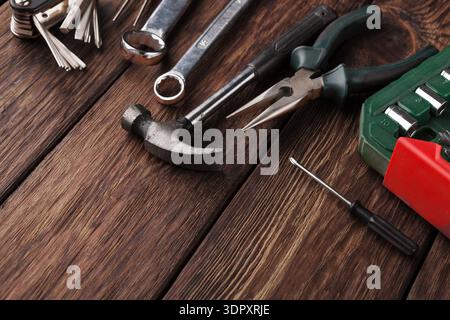 Various Tools Laid out on a Wooden Table for Repair Work and DIY Projects Stock Photo