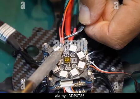 Soldering the power wires to the drone controller board Stock Photo