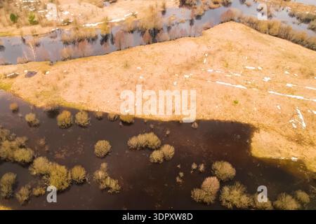 Overflowing rivers flood coastal meadows and trees. Stock Photo