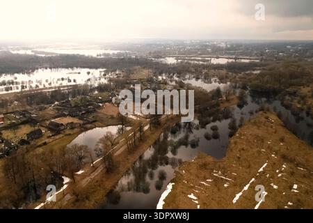 Overflowing rivers flood coastal meadows and trees. Stock Photo