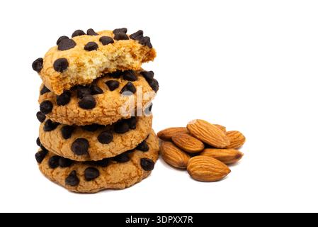 Three chocolate chip cookies stacked next to a small pile of almonds, isolated on a white background. Healthy snack ingredients combined. High quality Stock Photo