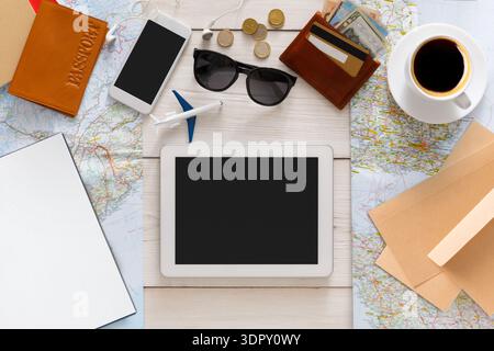 Travel Planning Setup With Map, Devices, and Essentials Prepared on the Table Stock Photo