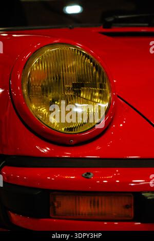 Close-Up of Right Front Headlight on Red 1975 RUF SCR 3.2 with Yellow Lens Stock Photo