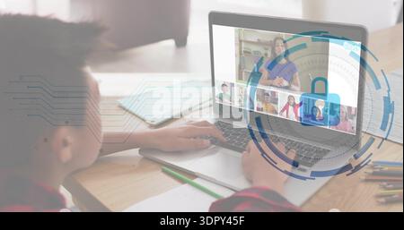 Sitting boy wearing red top attending online class at home, with laptop lock graphic, copy space Stock Photo