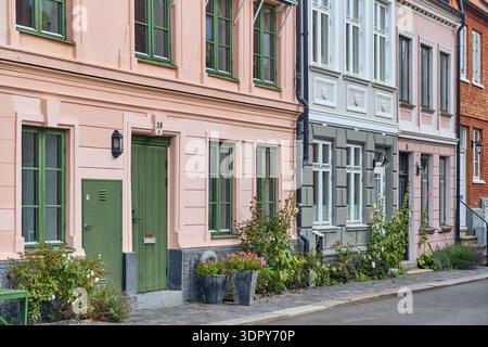Helsingborg, Sweden - 12 August 2025: View of pastel-colored buildings stand shoulder-to-shoulder, their vibrant facades creating a picturesque street Stock Photo
