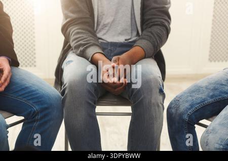 Group Meeting in a Room With Three People Sitting on Chairs Discussing Ideas and Sharing Thoughts Stock Photo