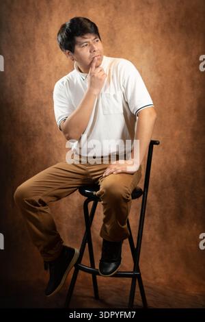 Thoughtful young man in studio Stock Photo
