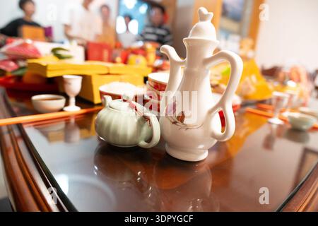 Chinese Tea Set on Polished Table with Traditional Dining Background in Home Setting Stock Photo