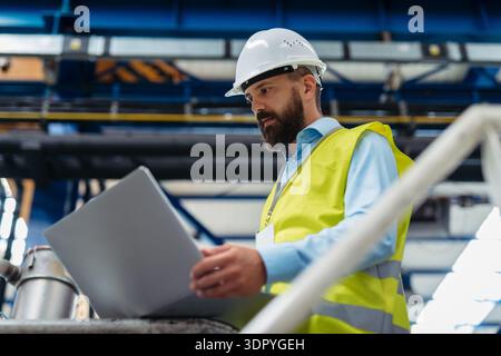 A portrait of project manager or engineer working on laptop. Stock Photo
