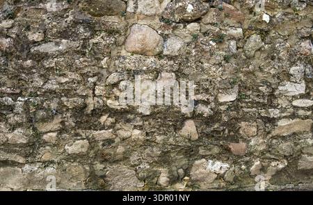 Close-up of aged limestone blocks with rough texture. Stock Photo