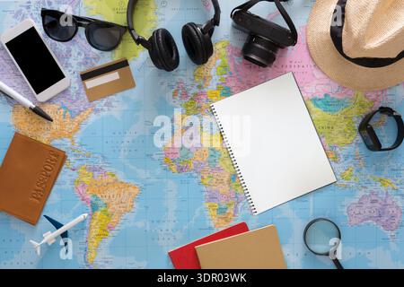 Planning a Travel Adventure With Essentials on a World Map in a Flat Lay Setup Stock Photo