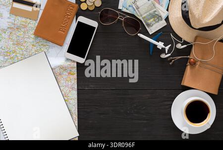 Planning a Trip With Travel Essentials on a Wooden Table Stock Photo