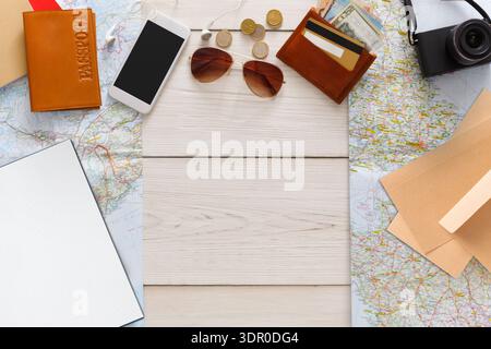 Travel Planning Essentials Are Laid out on a Wooden Table With Maps and Travel Items Stock Photo