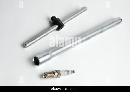 Spark plug for cars with a gasoline engine on an isolated white background Stock Photo