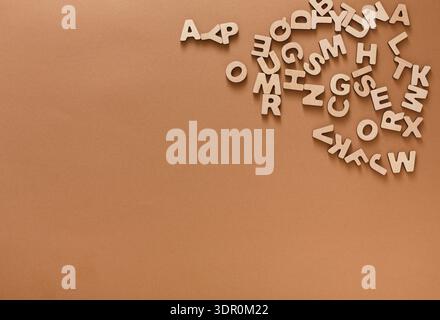 Wooden Letters Scattered on a Brown Surface During a Creative Activity for Learning Stock Photo