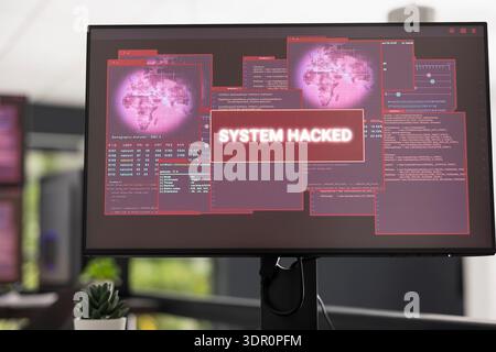 Close up of computer screen in empty office displaying system hack warning messages and critical alerts. Scene emphasizes cybercrime, compromised networks, and the importance of digital protection. Stock Photo