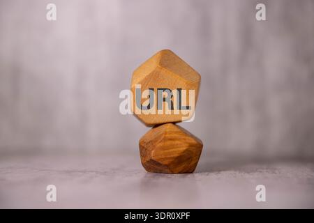 The computer keyboard has a pen and a blue sticker with the text URL Uniform Resource Locator. Flat lay. Stock Photo