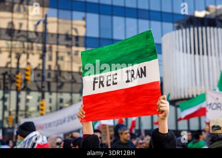 Vancouver, Canada - January 18,2026: Protester holds sign reading FREE IRAN on Iranian flag colors at opposition rally Stock Photo
