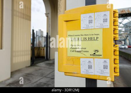 Vancouver, Canada - January 18,2026: Yellow crisis intervention box reading THERE IS HELP mounted on column at Vancouver bridge with instructions to c Stock Photo