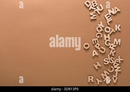Wooden Letters Scattered on a Brown Surface Create an Interesting Arrangement for Fun Activities Stock Photo