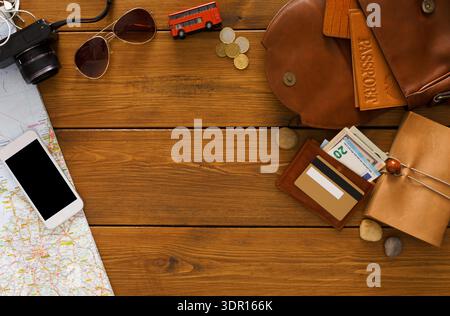 Travel Gear and Essentials Laid out on a Wooden Table for a Journey Planning Session Stock Photo