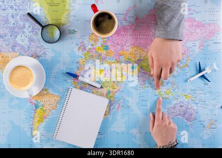 Exploring Travel Plans With a World Map and Coffee on a Table Stock Photo