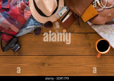 Travel Essentials Laid out on a Wooden Table With Accessories and a Cup of Coffee Stock Photo