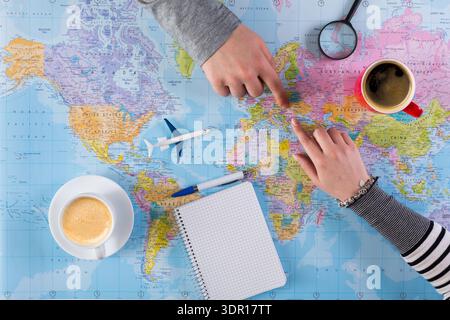 Planning a Trip With Maps, Coffee, and Notes on a Table Stock Photo