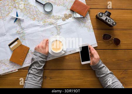 Planning a Travel Adventure With a Map, Coffee, and Devices on a Wooden Table Stock Photo