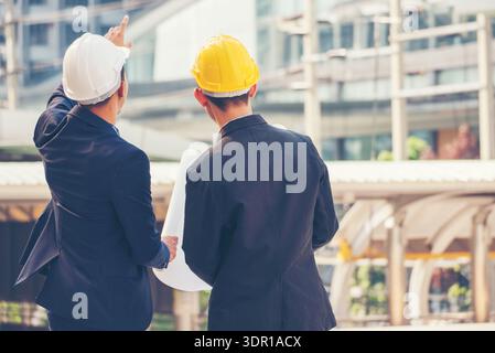 Civil Construction engineer teams shaking hands together wear work helmets worker on construction site. Foreman industry project working engineer team Stock Photo