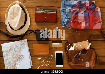 Items Laid out for Travel Preparation on a Wooden Table Stock Photo