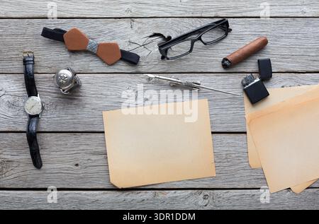 Collection of Various Office Supplies and Personal Items on a Wooden Table in Daylight Stock Photo