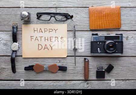 Gift Ideas for Father's Day With Camera, Watch, and Other Items on Wooden Table Stock Photo