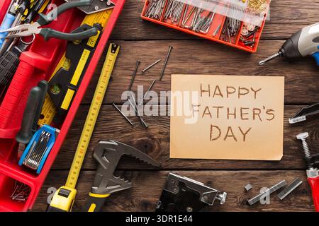 Tools and Greetings for Father's Day Celebration on a Wooden Table With Various Items Laid Out Stock Photo